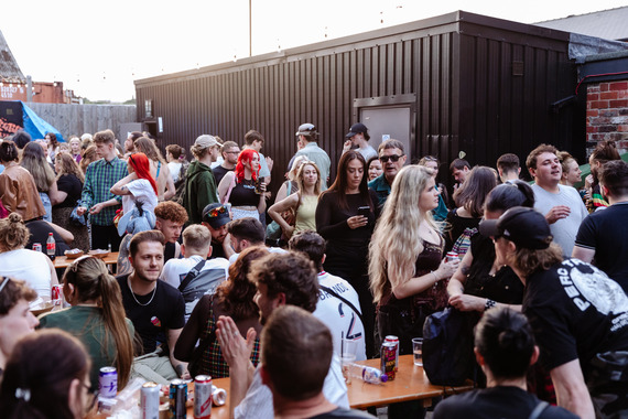 Sea of people in beer garden at day rave.