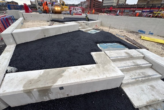 Fresh tarmac between lower rear rampart walls next to a stepped area of the castlegate site