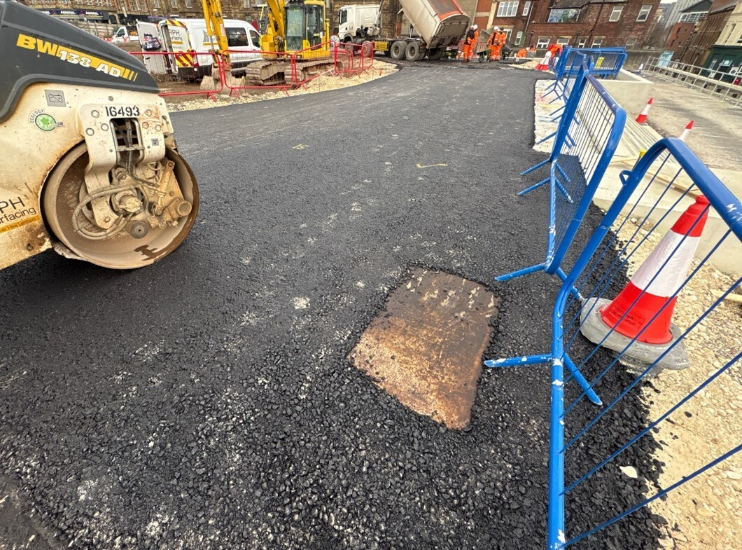 A freshly tarmacked surface on site at Castlegate with a steamroller in the front and diggers in the back
