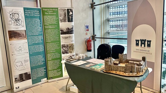 The Friends of Sheffield Castle stand at the Sheffield Heritage fair with the model of Sheffield Castle and banners in the background