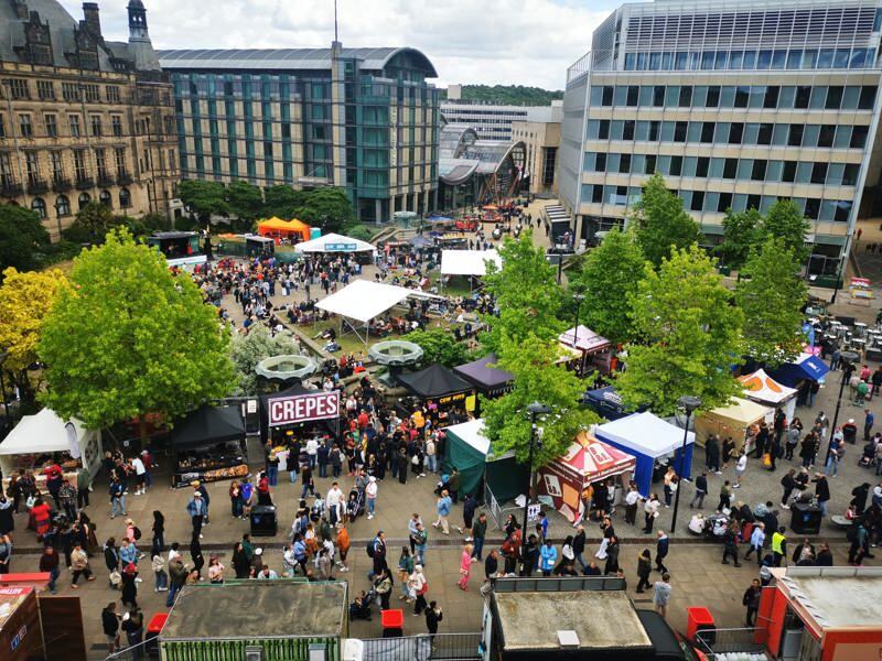 The Peace Gardens surrounded by food stalls and busy crowds.