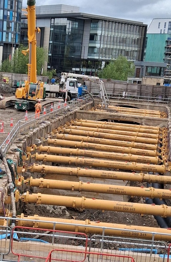 A crane over the exposed river sheaf with yellow supporting beams