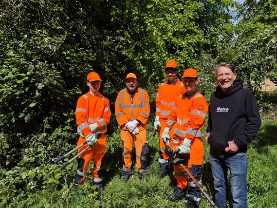 The Environmental Stewardship Team in orange high vis clothing alongside Matthew Nimmo, Head of Estates Regeneration