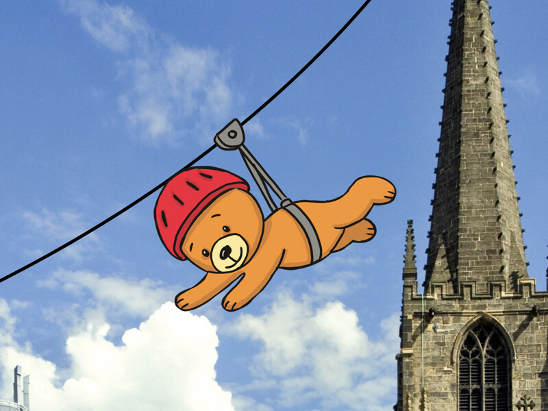 The sky above Sheffield Cathedral, with an illustrated teddy bear shooting across a zip line.