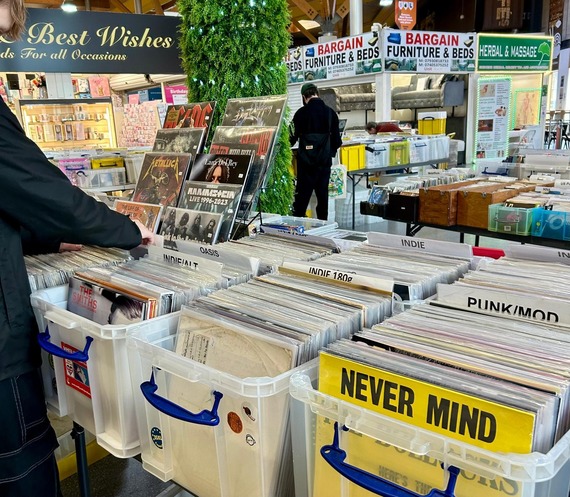 Boxes of colourful records at a record fair in Moor Market.