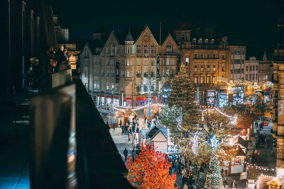 A view of Christmas lights, market stalls and a large tree on Fargate.