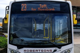 A bus sits at the viking bus station ready to depart north