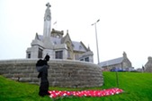 Knitted poppy and silhouette display at the county war memorial