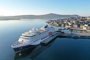Hanseatic Nature, a large cruise ship sits alongside the pier in Lerwick Harbour