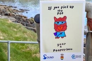 A sign encouraging dog owners to pick up poo designed by school children