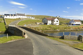 A small road bridge at Bridge End in Burra - the road beyond it winds uphill steadily.