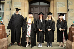 Young people wearing graduation robes outside of Lerwick Town Hall