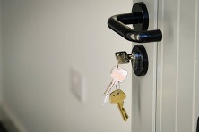 A set of keys hanging from a door lock
