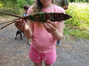 image of child                                          holding willow fish
