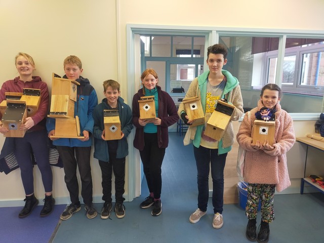 Young Ranger showing off their bird boxes which they have made