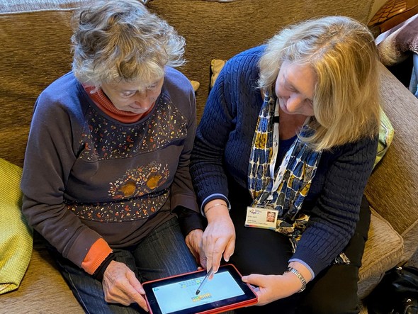 Monica Cook and Janet Guice working on a tablet
