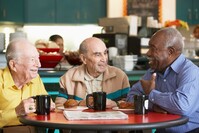 older people talking at a table