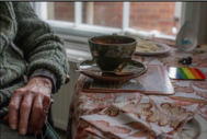 older lgbt person sitting at a table