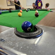 young people playing pool
