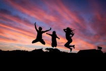 three people jumping 