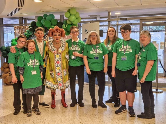 groups of young volunteers in green t-shirts at pantomime