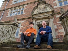 tim ashton and jacob chandler sit on the steps of soulton hall