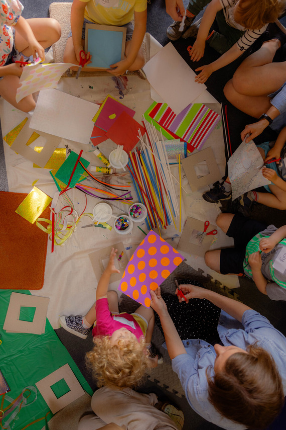 Children sat in a circle with craft materials