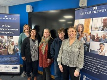 people standing by a banner