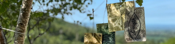 ceramic flags hung up in trees