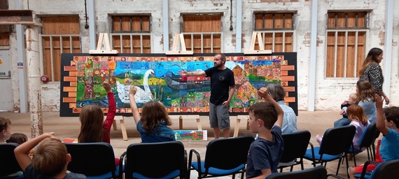 a storyteller stands in front of a group of people