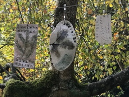 photograph of the clay tiles hanging in the trees