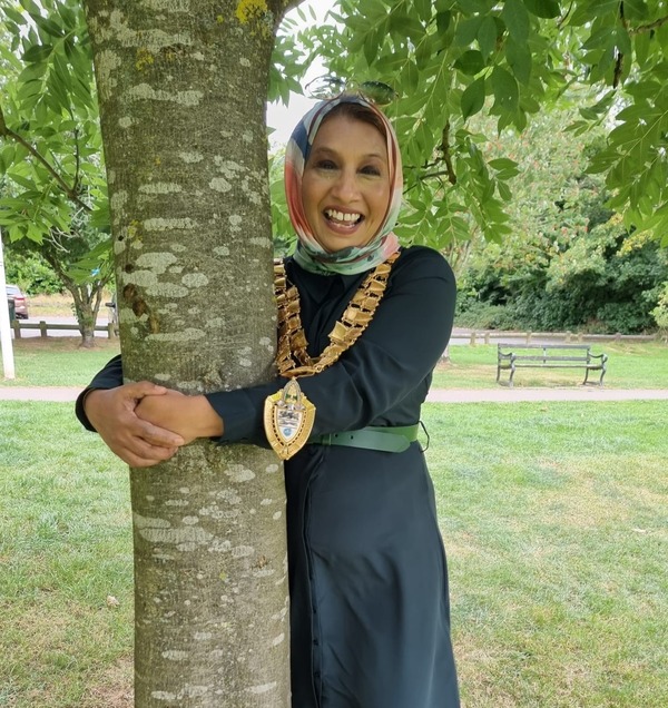 Mayor hugging a tree