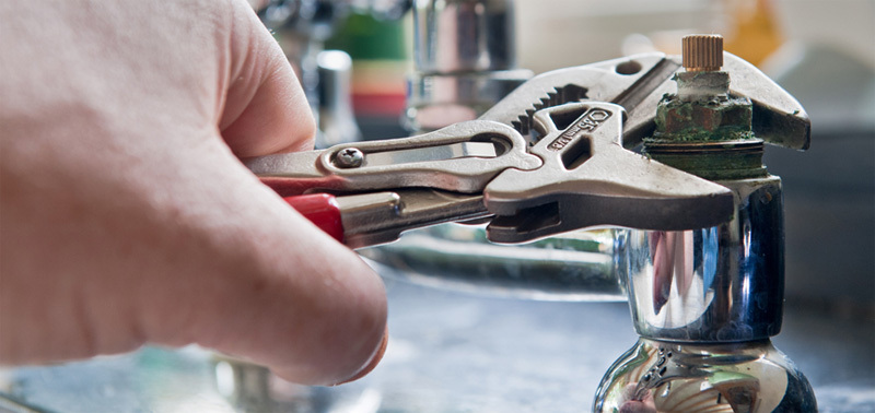 A sink tap being repaired