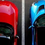 Top down view of red and blue cars parked side by side