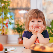Smiling child with cooking supplies