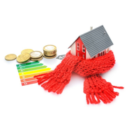 Money one table next to small model house wearing a red scarf