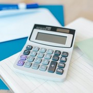 Calculator on top of a pad of lined paper