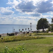 View over Western Esplanade grassy area, seafront road and sea.