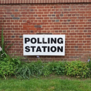 Polling station sign on a wall