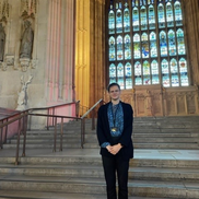 Youth Parliament member Madi Faulkner-Hatt standing inside the House of Commons.