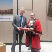Southend Mayor in his ceremonial robes posing for a photo in the council chambers with David Stanley of the Music Man Project.