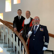 Ron Woodley in his Mayoral robes standing on the civic staircase with Chief Executive Colin Ansell and Mayor's Officer and Macebearer Adam Tregoning.