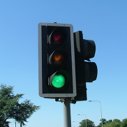 A set of traffic lights. The green light is lit to signal go.