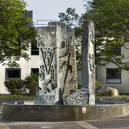 The fountain that sits outside of the Civic Centre building. 3 carved pillars standing within a low brick finished base.