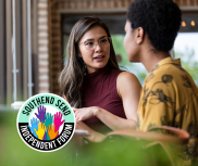 Two women engaged in conversation. The SSIF logo in on the bottom left of the image.