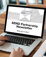 An open laptop with the text SEND Partnership newsletter on the screen.
