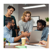 People working together around a laptop on a table.