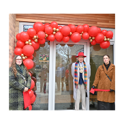 Representatives from the Parent Carer Forum and Southend's Mayor in front of the ARB with a red ribbon and red and golden balloons.