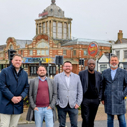 Five people standing in front of the historic Kursaal building in Southend-on-Sea.