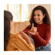 Two women communicating using British Sign Language.